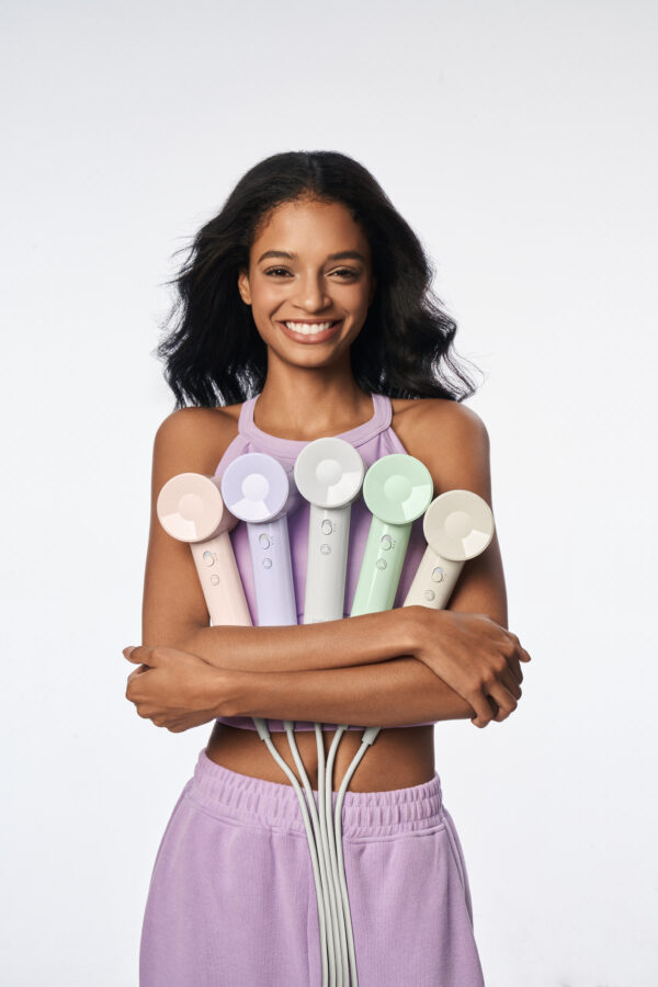 Woman holding five SE Lite hair dryers